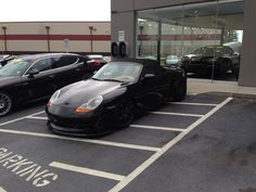 two porsches are parked in the parking lot next to each other outside a building