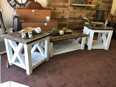 three wooden tables sitting next to each other in front of a wall with clocks on it