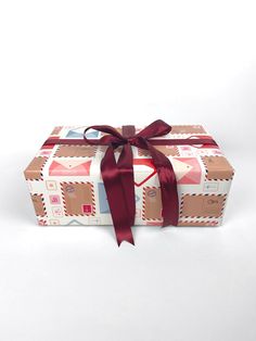 a wrapped gift box with a red ribbon tied around the top and bottom, on a white background