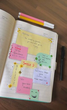 an open notebook with sticky notes on it