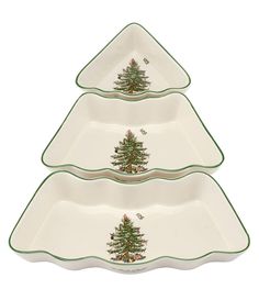 three serving trays with christmas trees on the bottom and green trimming around them