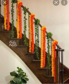 some orange and yellow balloons are hanging on the banisters in front of a staircase