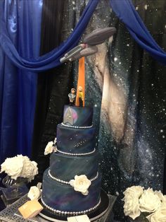 a space themed wedding cake on display