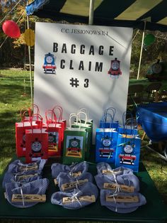 bags with thomas the train on them are for sale at a children's birthday party