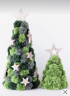 two small christmas trees with stars on them