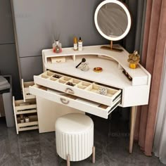 a white vanity with drawers and a stool