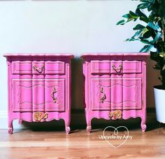 two pink dressers are next to a potted plant