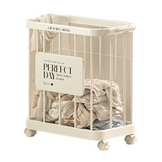 a white baby crib filled with lots of clothes on wheels and a sign that says, the perfect day