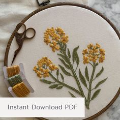 an embroidery project with yellow flowers and scissors