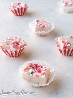 several cupcakes with white frosting and sprinkles