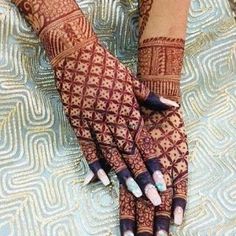 two hands with henna designs on them