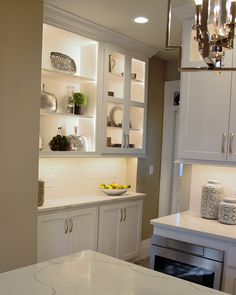 the kitchen is clean and ready to be used for cooking or baking, with white cabinets