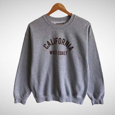 CODE : 541/21 Vintage California West Coast Grey Sweatshirt California Crewneck West Coast Sweater Pullover Jumper California Spell Out Print Logo Jumper  Size on Tag : S Details Measurement  Arm Pit to Arm Pit : 22"inches Back Collar to Hem : 26"inches Condition :  Great Vintage Condition.(No Holes And No Stain.Please refer pictures detail.‼️ 📮 SHIPING > WE ARE USING DHL EXPRESS SHIPING ITS TAKE 3-5 ARRIVE.PLEASE DROP YOUR PHONE NUMBER AFTER PURCHASE.📮 California 90s, California Sweatshirt, 90s Crewneck, College Sweatshirt, Vintage California, Grey Crewneck, Embroidered Crewneck, Sweatshirt Vintage, Sweater Pullover