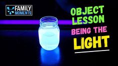 a glass jar filled with water sitting on top of a table next to a neon sign