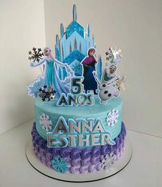 a frozen princess birthday cake with frosting and decorations