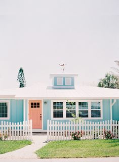 a blue house with a white picket fence