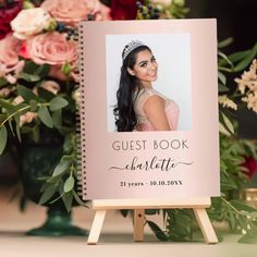 the guest book for charlotte is displayed on an easel with flowers in the background