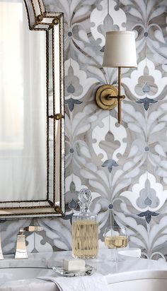 a white sink sitting under a bathroom mirror next to a wall mounted faucet