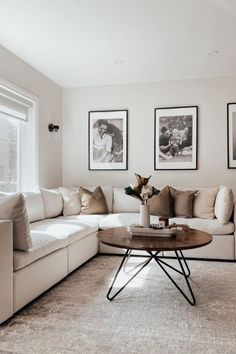 a living room filled with furniture and pictures on the wall