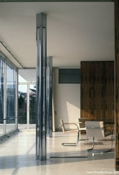 an empty room with chairs and sliding glass doors