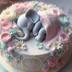 there is a cake decorated with flowers and an elephant