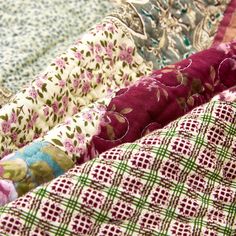 many different fabrics are stacked together on top of each other in this close up photo