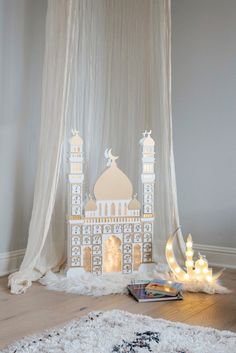 a white and gold marquee with some lights on it in front of a curtain