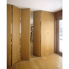 an empty room with wooden doors and bookshelves