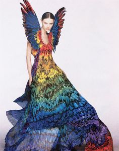 a woman in a multicolored dress with wings