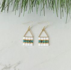 the earrings are made with white and blue beads