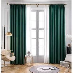 a living room filled with furniture and green curtains