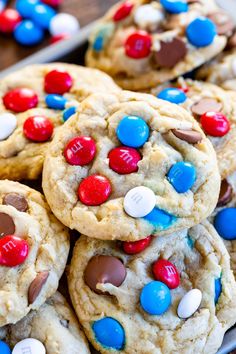 cookies with m & m's and m's on them are piled together