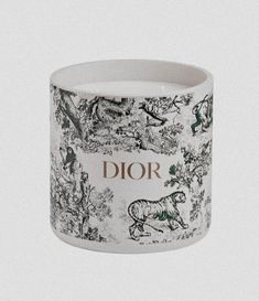 a white and black cup with the words dior printed on it