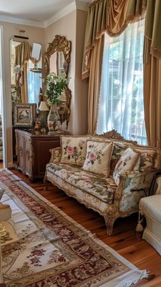 a living room filled with furniture and windows covered in curtained drapes, sitting on top of a hard wood floor