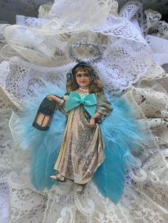 a doll with a lantern on top of lace