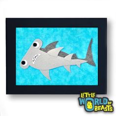 a paper cut out of a shark with big eyes on it's face and mouth