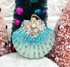 a blue purse sitting on top of a white table next to christmas trees and ornaments