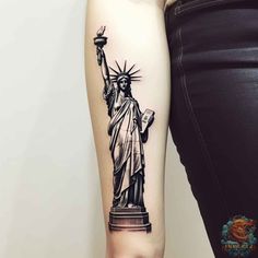 the statue of liberty tattoo on the right inner arm is shown in black and white