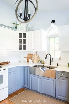 a kitchen with blue cabinets and white appliances