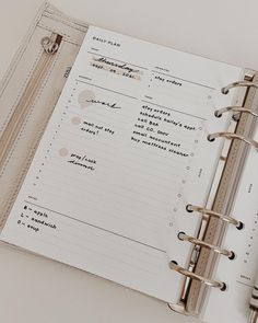 an open planner book sitting on top of a table