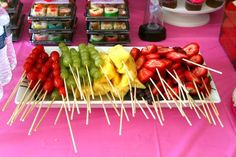 there are many fruits and vegetables on the table with toothpicks in front of them