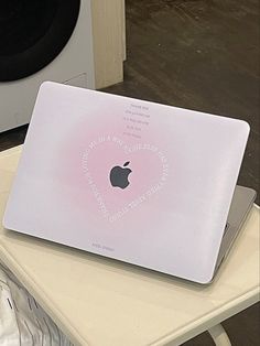 an apple laptop sitting on top of a table