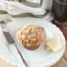 a white plate topped with a muffin and butter