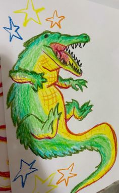 a child's drawing of a crocodile with stars on the side and in the background