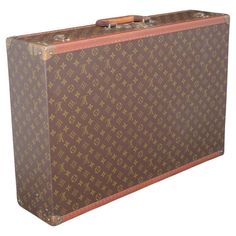 Louis Vuitton large ‘Fly-el’ suitcase in LV monogram pattern coated canvas with edges trimmed in lozine, a layered leather flat handle and unpolished brass fittings. Securing the lid of the case is a central sprung catch with a lock, accompanied by two additional latches. The interior is lined with cream coated canvas and features two fabric straps. Circa 1985. Dimensions: 70cm/ 28 inches (width) x 47cm/ 18 inches (depth) x 18cm/ 7 inches (height). Louis Vuitton was founded by its namesake in 1854, with the first shop on Rue Neuve des Capucines in Paris, France. Monsieur Vuitton had observed that a competitor's trunk could be easily stacked and in 1858, Vuitton introduced his flat-topped trunks with trianon canvas covering, making them lightweight and airtight. Before this time, rounded-to Cream Coat, Color Crema, Monogram Pattern, S Monogram, Lv Monogram, Coat Patterns, Brass Fittings, Leather Flats, Luxury Travel