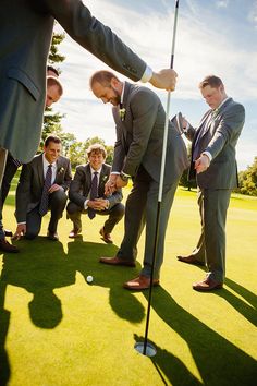 a group of men in suits and ties playing golf