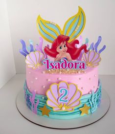 a birthday cake decorated with the little mermaid