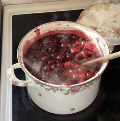 a pot filled with cranberry sauce on top of a stove