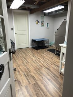 an empty room with hard wood floors and white walls is seen in this image from the doorway