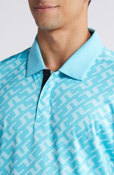 Stretchy, sweat-wicking fabric patterned in bright logos brings all-activity comfort to a polo that dries quickly and feels soft against your skin. 29" length (size Medium) Hidden-button placket Spread collar Short sleeves Moisture-wicking fabric engineered for dryness and comfort 100% polyester Machine wash, tumble dry Imported Blue Graphic Print Polo Shirt For Sports Events, Sporty Graphic Print Polo Shirt, Blue Moisture-wicking Polo Shirt With Collar, Sporty Golf Polo Shirt With Graphic Print, Blue Moisture-wicking Polo Shirt, Casual Blue Moisture-wicking Polo Shirt, Blue Casual Polo Shirt For Sports, Blue Collared Polo Shirt With Moisture-wicking, Blue Moisture-wicking Casual Polo Shirt